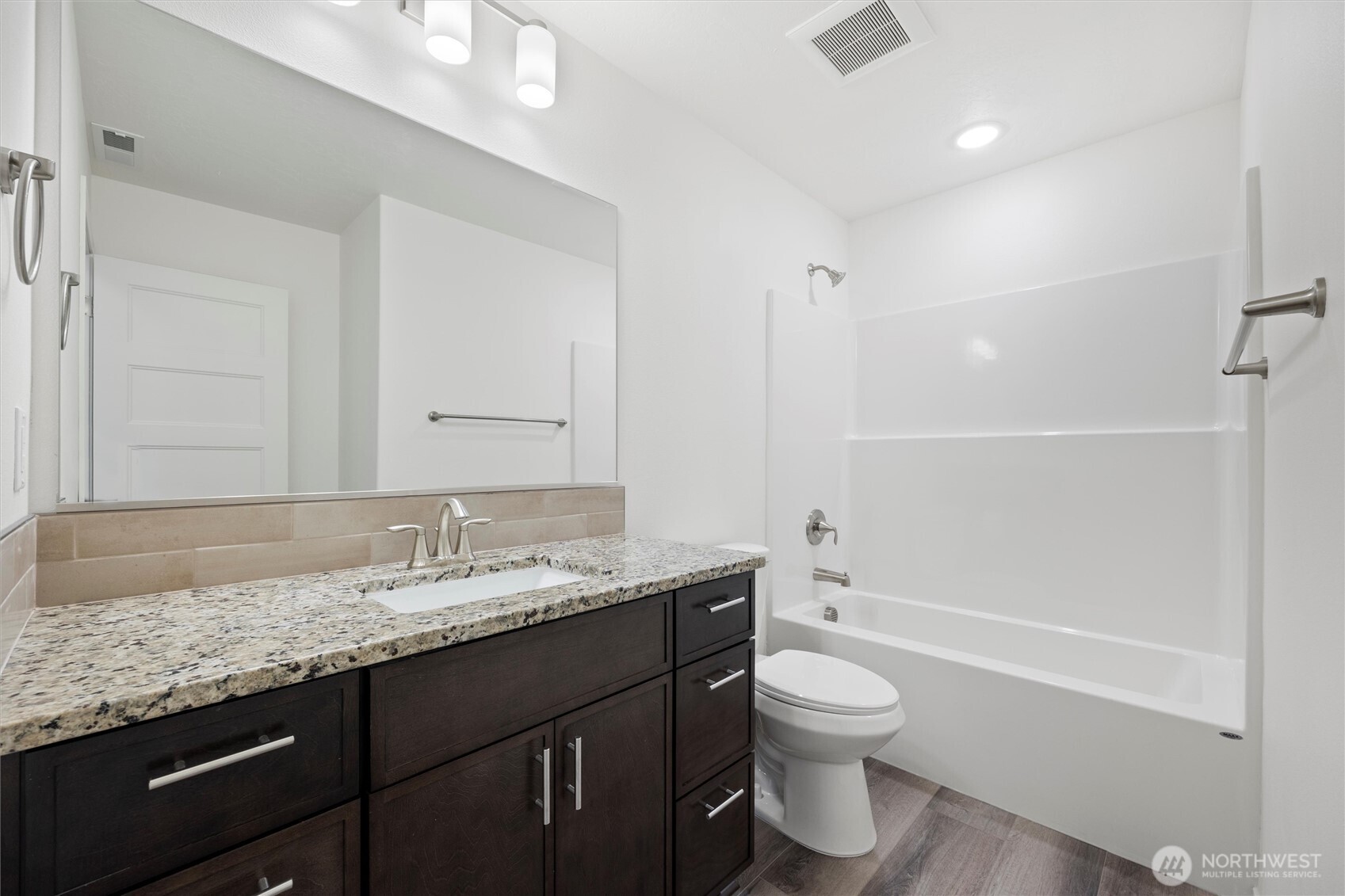 1507 South 5th Street Dayton, WA 99328 - Photo 20 of 35 a bathroom with a granite countertop sink a toilet and shower