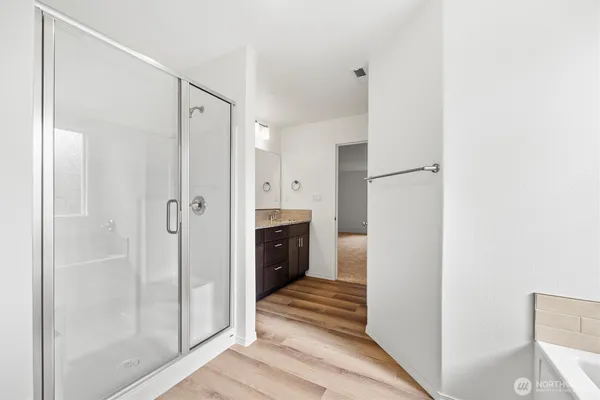 a bathroom with a shower and a mirror
