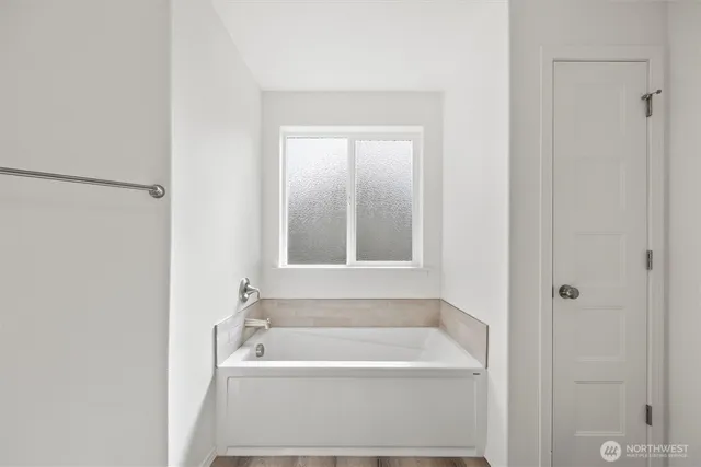 a bath tub sitting next to a white sink