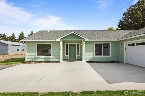 a front view of a house with a garden and yard