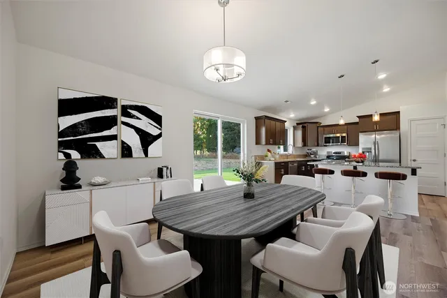 a view of a dining room with furniture and wooden floor