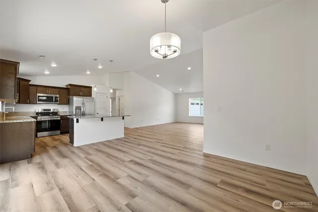 a view of a kitchen with a sink stainless steel appliances and cabinets