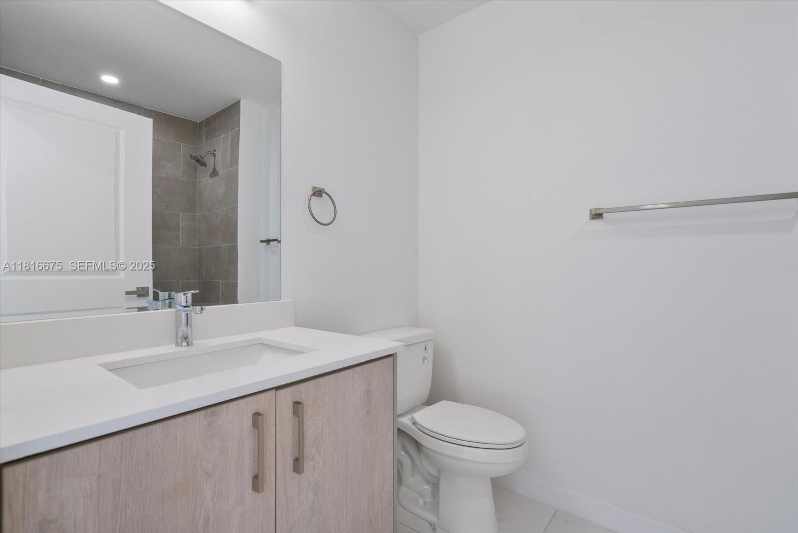 420 Southwest 7th Avenue, Unit 301 Miami, FL 33130 - Photo 13 of 19 a bathroom with a sink toilet and vanity