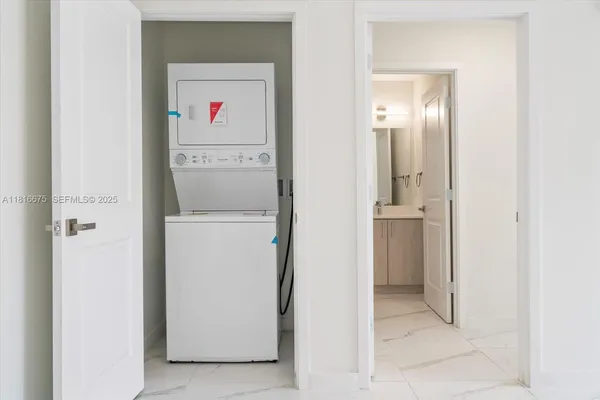 a utility room with closet dryer and washer