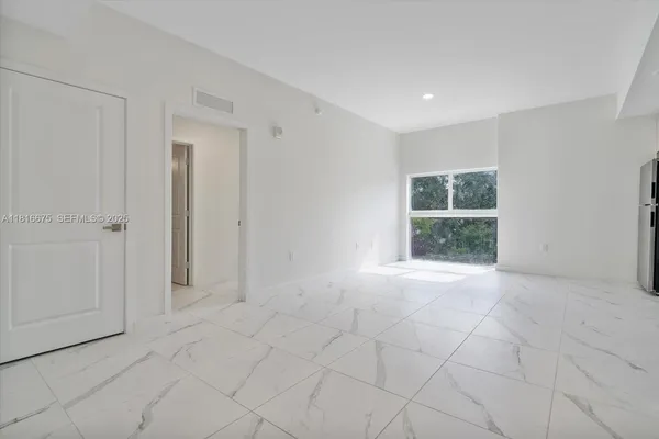 a view of an empty room with a window