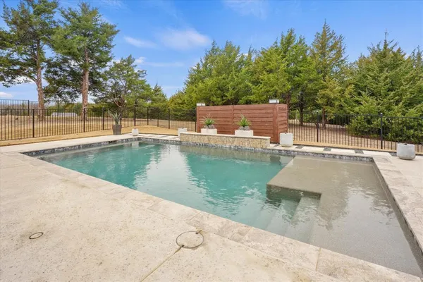 a view of a swimming pool with a yard