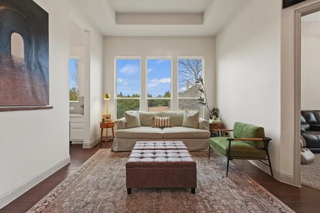 a view of a dining room with furniture large windows and wooden floor