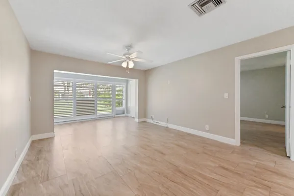 wooden floor in an empty room with a window