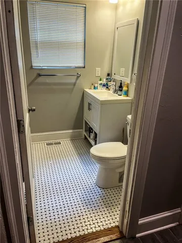a bathroom with a sink toilet a mirror and vanity