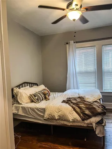 a bedroom with a bed and a mirror