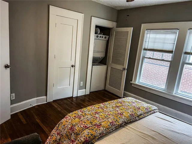 a view of a workspace room with wooden floor and furniture