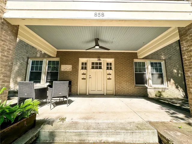 a front view of a house with a barbeque