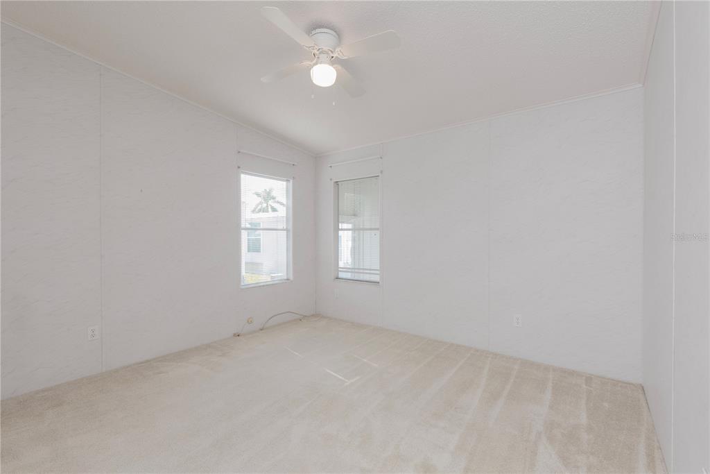 1001 Starkey Road, Unit 767 Largo, FL 33771 - Photo 11 of 41 an empty room with a window and ceiling fan