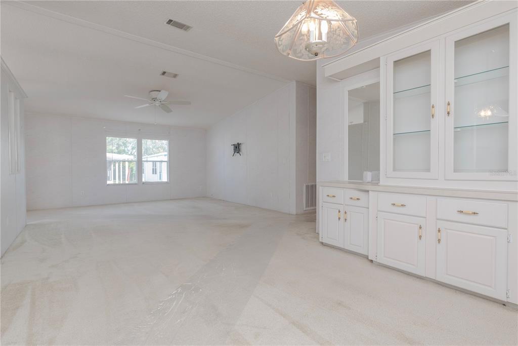 1001 Starkey Road, Unit 767 Largo, FL 33771 - Photo 14 of 41 an empty room with chandelier fan