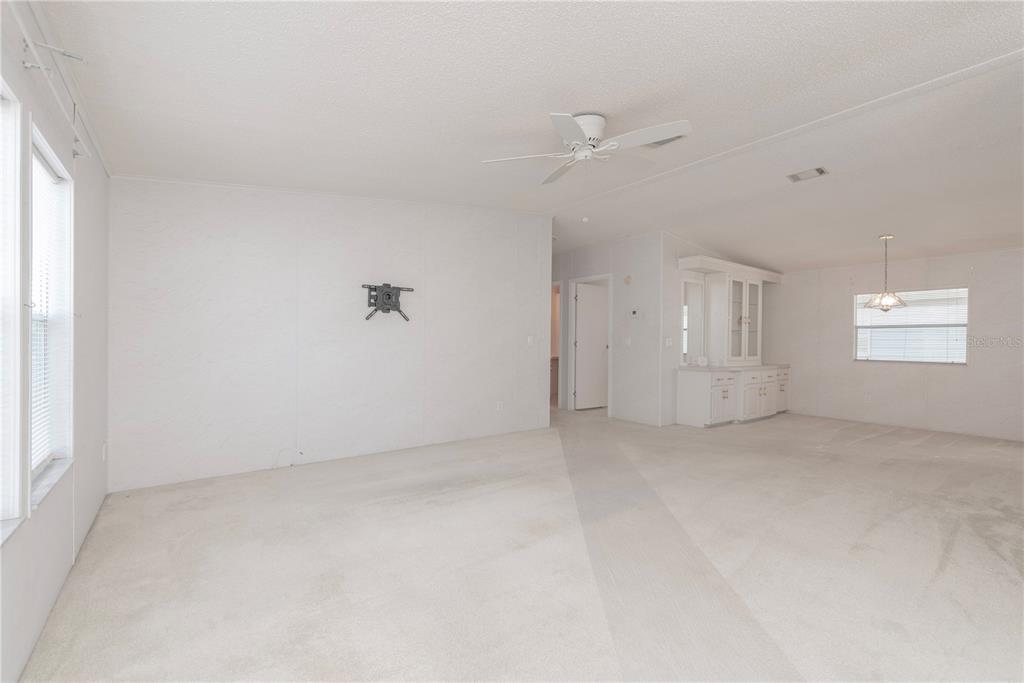 1001 Starkey Road, Unit 767 Largo, FL 33771 - Photo 15 of 41 an empty room with windows and entrance to other room