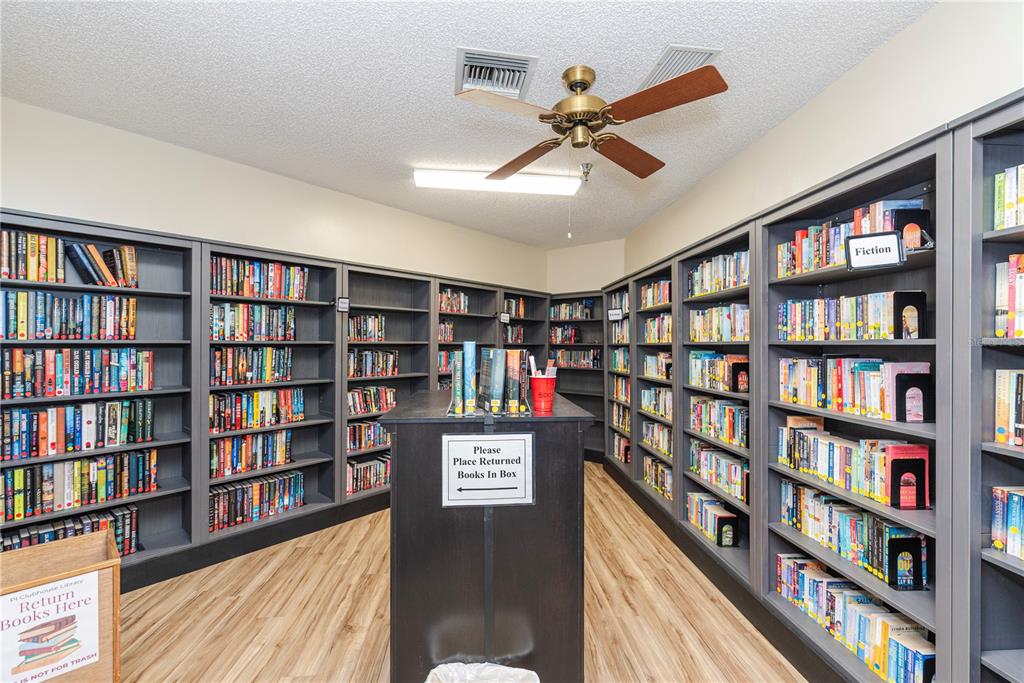 1001 Starkey Road, Unit 767 Largo, FL 33771 - Photo 27 of 41 a view of a livingroom with a bookshelf and a bookshelf