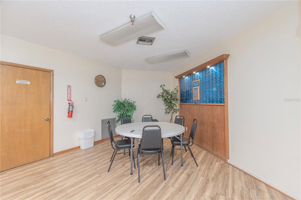 1001 Starkey Road, Unit 767 Largo, FL 33771 - Photo 32 of 41 a view of a dining room with furniture and wooden floor