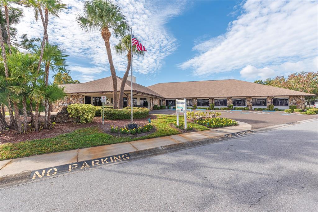 1001 Starkey Road, Unit 767 Largo, FL 33771 - Photo 37 of 41 a front view of a house with a yard and lake view