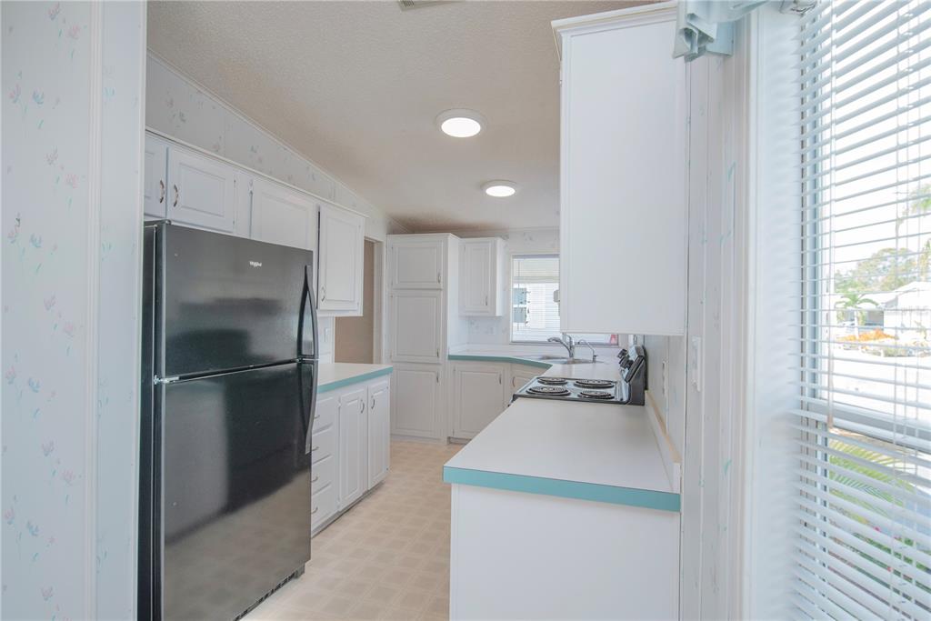 1001 Starkey Road, Unit 767 Largo, FL 33771 - Photo 6 of 41 a kitchen with a sink and refrigerator