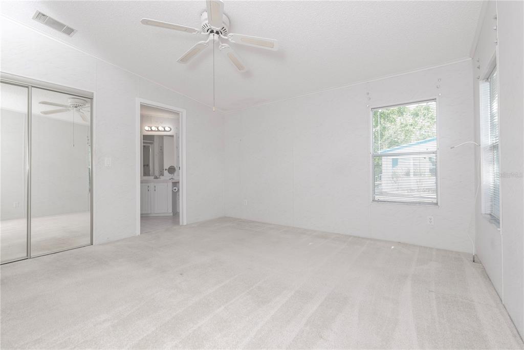 1001 Starkey Road, Unit 767 Largo, FL 33771 - Photo 7 of 41 an empty room with fan and windows