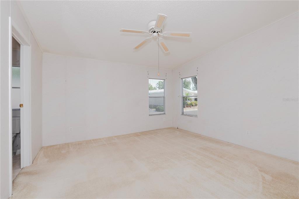 1001 Starkey Road, Unit 767 Largo, FL 33771 - Photo 8 of 41 an empty room with fan and windows