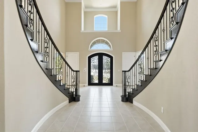 a view of staircase with wooden floor and a large window