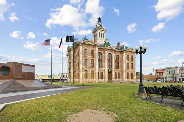 a front view of a building with a yard