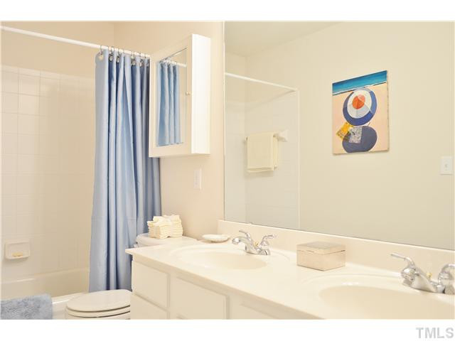 3723 Old Post Road Raleigh, NC 27612 - Photo 17 of 25 a bathroom with a sink and a mirror