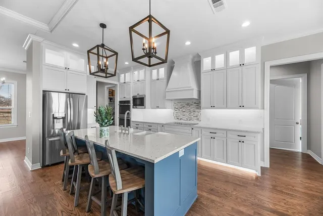 a dining room with furniture a chandelier and wooden floor