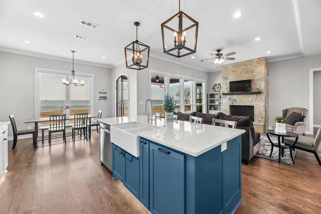 a kitchen with cabinets a dining table and chairs