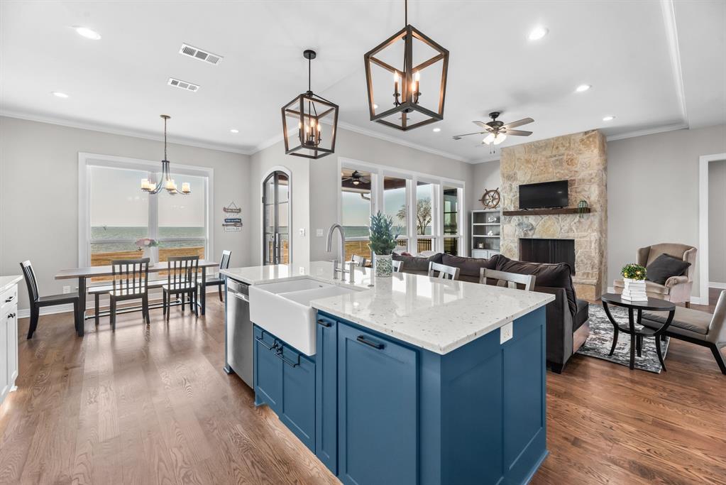 3016 Lake Ridge Drive Streetman, TX 75859 - Photo 13 of 40 The large quartz topped island provides seating and a lovely farmhouse sink...the chef of the kitchen will appreciate prepping while still being involved with the activities in the living area!
