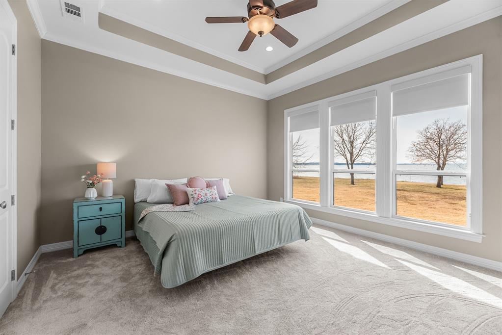 3016 Lake Ridge Drive Streetman, TX 75859 - Photo 15 of 40 The primary bedroom provides gorgeous lake views and an elevated ceiling.