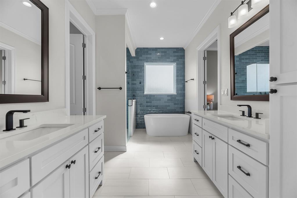 3016 Lake Ridge Drive Streetman, TX 75859 - Photo 16 of 40 The spacious primary bathroom features a huge walk in closet and separate vanities, along with lots of custom built cabinets to keep everything neat and tidy.