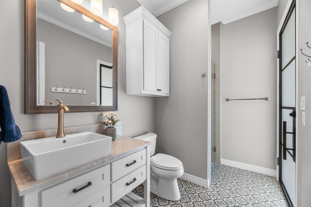 3016 Lake Ridge Drive Streetman, TX 75859 - Photo 25 of 40 This full bathroom also exits to the patio, making it perfect for cleaning up after lake day fun!