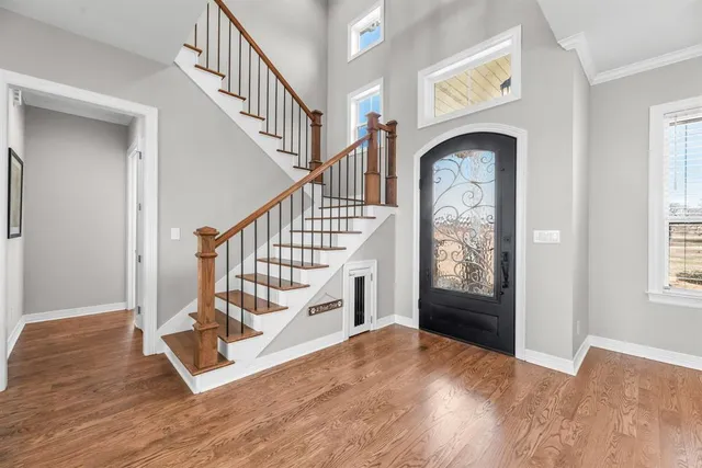 a view of entryway and hall with wooden floor