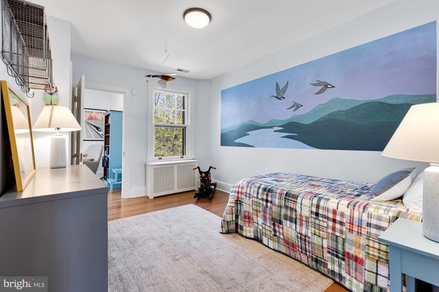 a bedroom with a bed and a desk