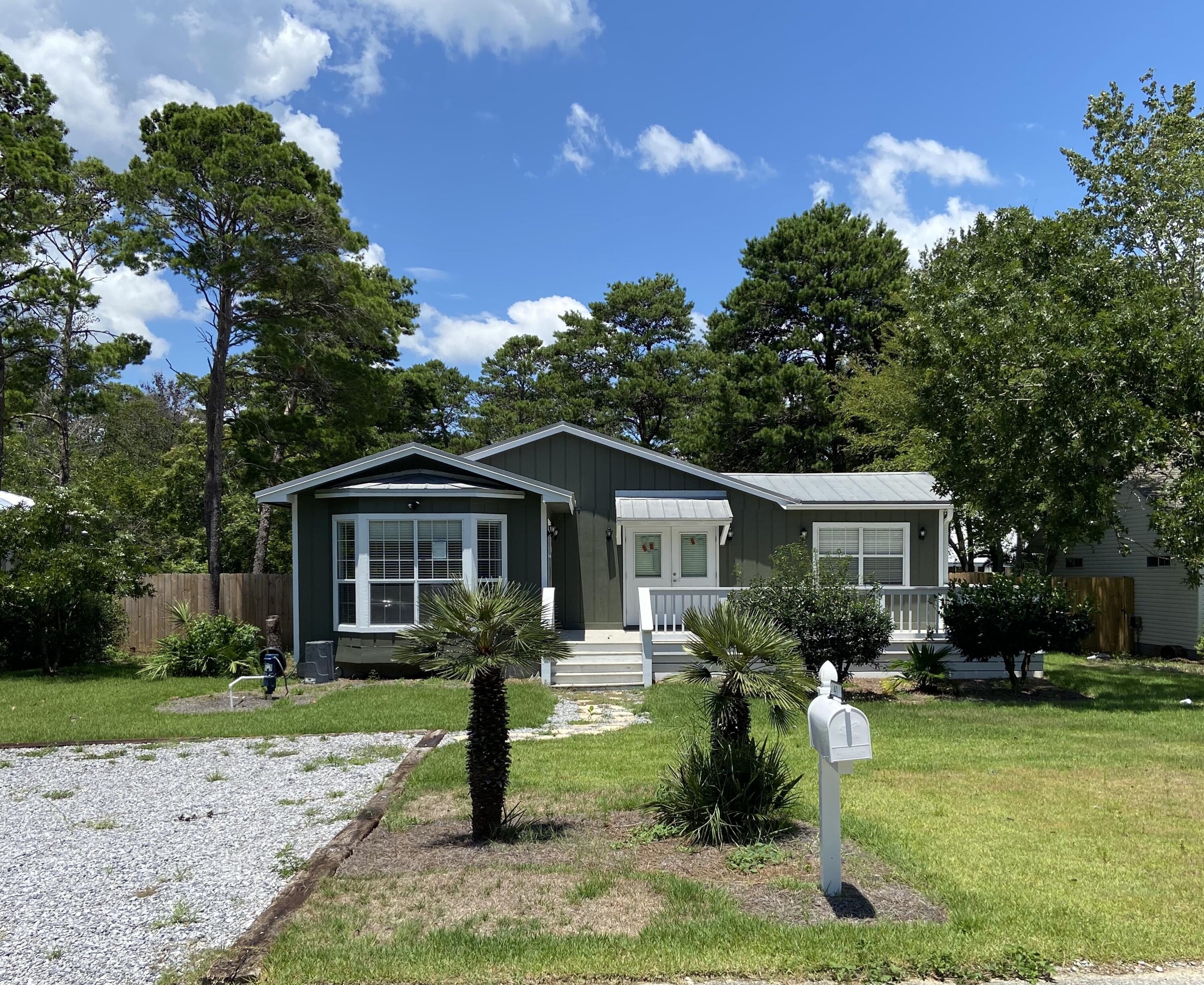 41 Bramble Street Santa Rosa Beach, FL 32459 - Photo 1 of 15 a front view of house with yard and green space