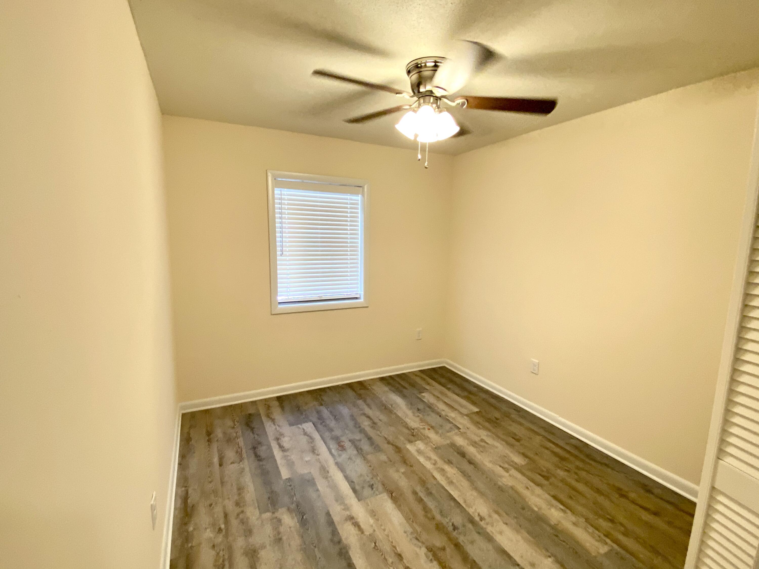 41 Bramble Street Santa Rosa Beach, FL 32459 - Photo 12 of 15 a view of an empty room with wooden floor and a window