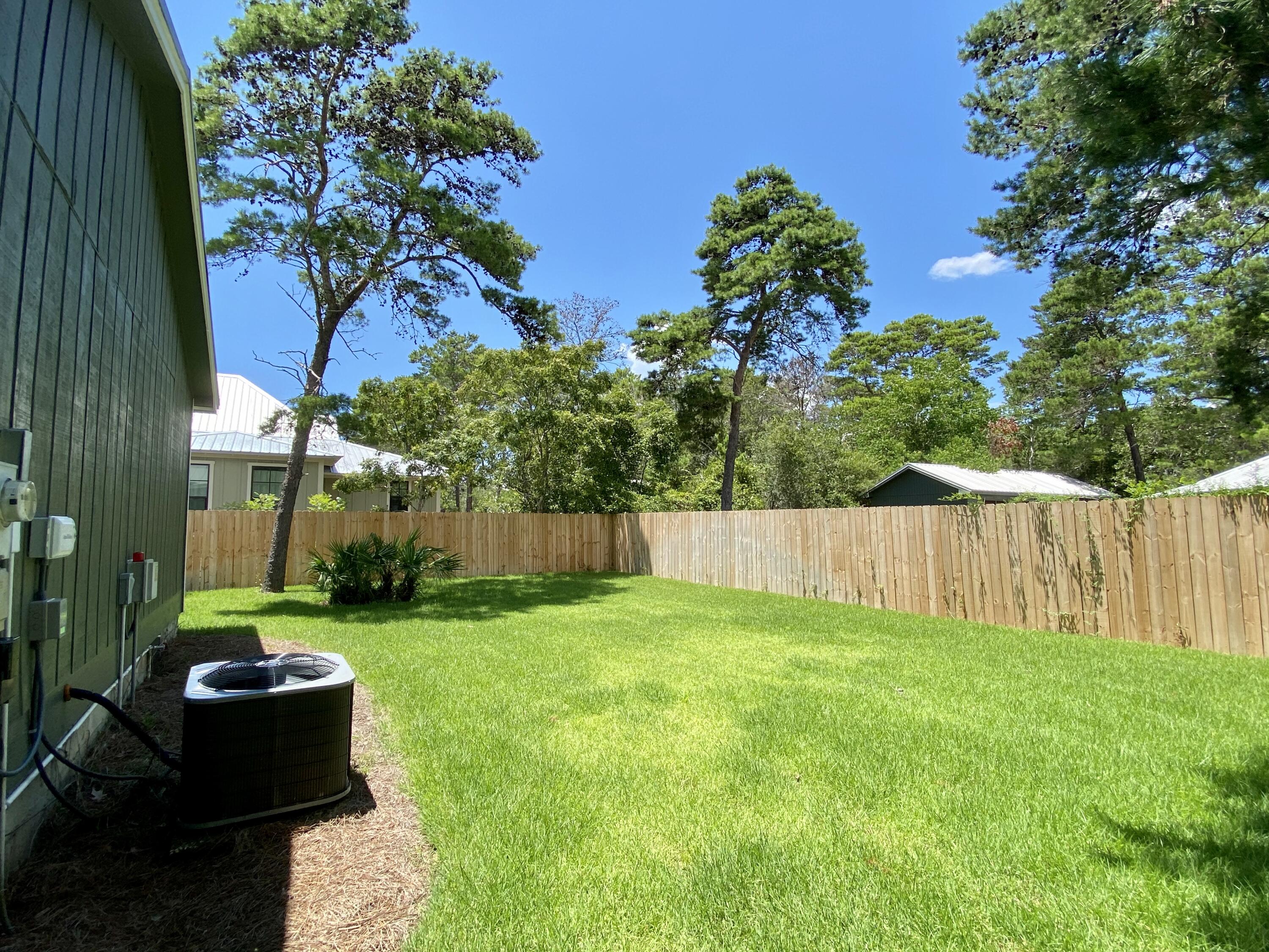41 Bramble Street Santa Rosa Beach, FL 32459 - Photo 6 of 15 a view of backyard with potted plants and a large tree