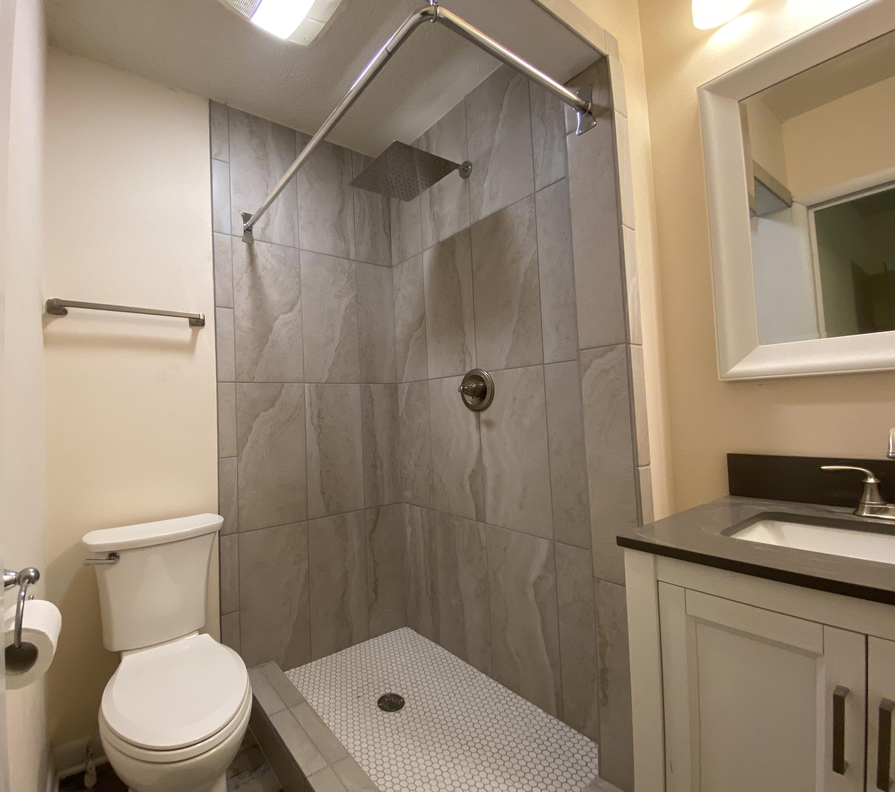 41 Bramble Street Santa Rosa Beach, FL 32459 - Photo 9 of 15 a white toilet sitting next to a bathroom sink