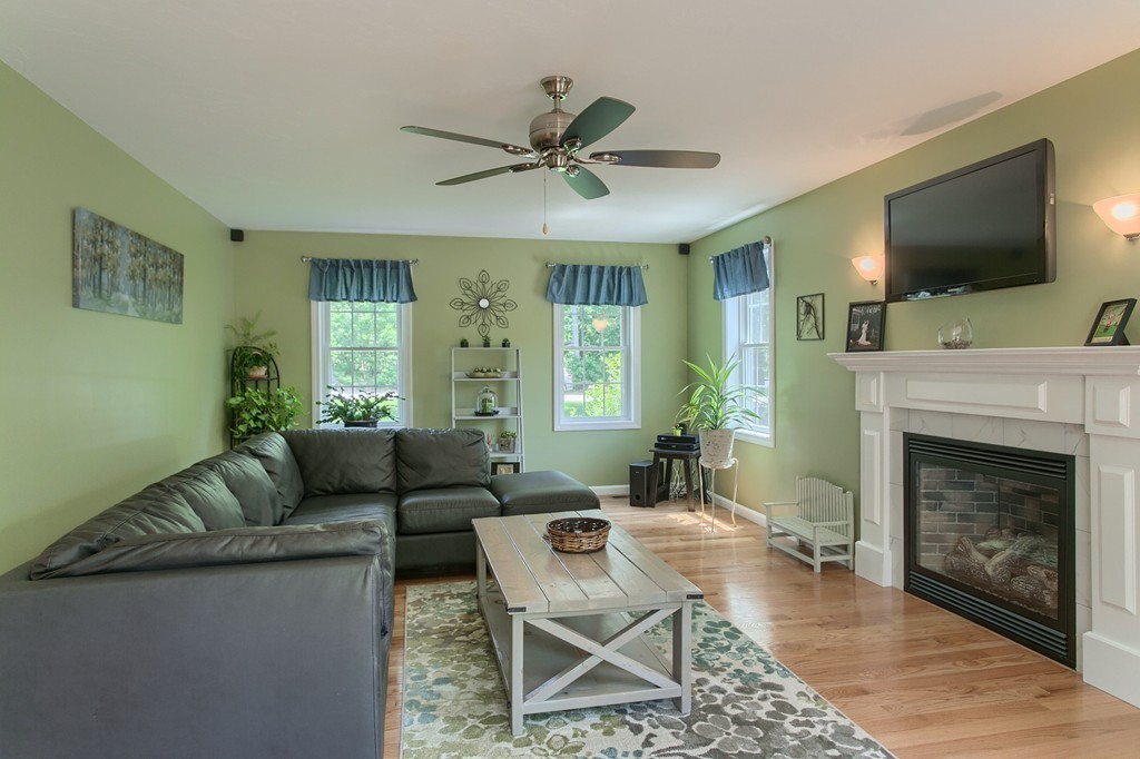 16 Adams Road Townsend, MA 01469 - Photo 8 of 30 a living room with furniture a flat screen tv and a fireplace