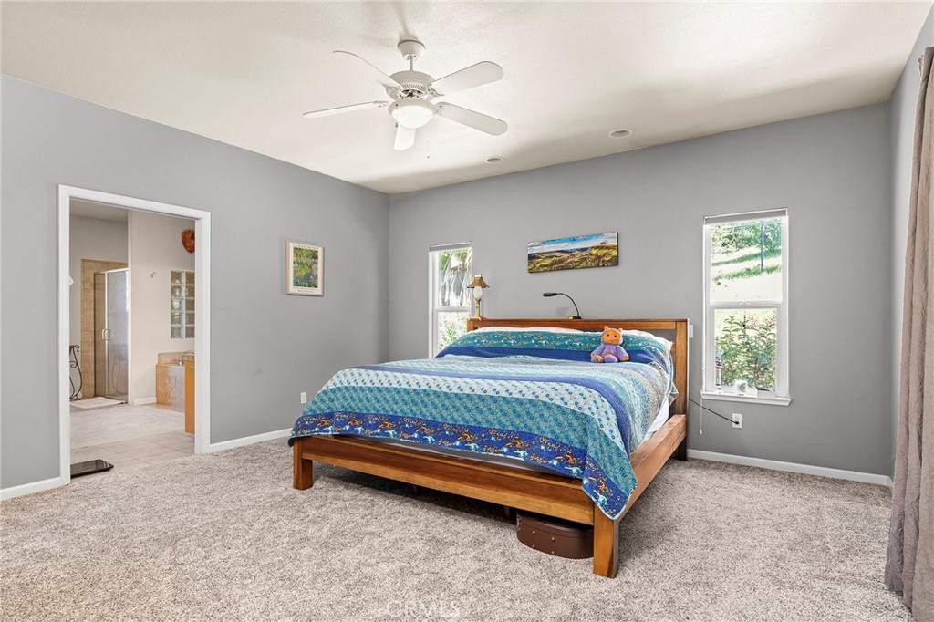 2262 Honey Run Road Chico, CA 95928 - Photo 13 of 74 a bedroom with a bed and a chandelier
