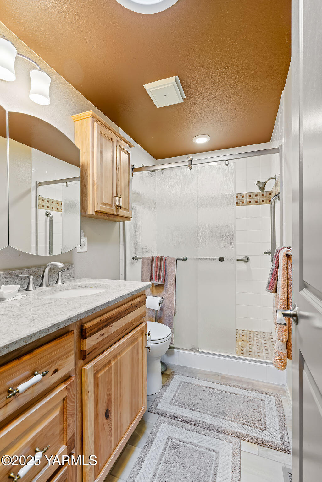250 Hexon Road Selah, WA 98942 - Photo 28 of 50 a bathroom with a granite countertop sink mirror vanity and toilet