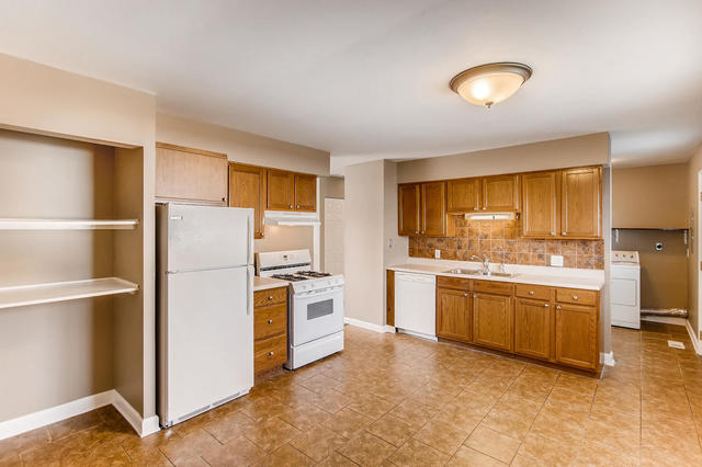 67 Saugatuck Road Montgomery, IL 60538 - Photo 4 of 17 a kitchen with stainless steel appliances granite countertop a refrigerator a stove and a sink