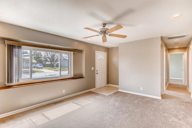 67 Saugatuck Road Montgomery, IL 60538 - Photo 5 of 17 wooden floor in an empty room with a window