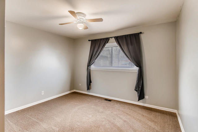 67 Saugatuck Road Montgomery, IL 60538 - Photo 7 of 17 an empty room with a ceiling fan and window