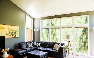 578 High Bench Road Alpine, UT 84004 - Photo 21 of 39 Vaulted ceiling living space featuring a large picture window, additional transom windows, sconce lighting, and wood-finish flooring