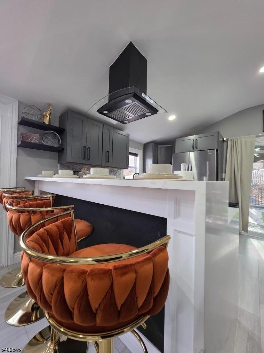 a kitchen with stainless steel appliances kitchen island granite countertop a sink a table and chairs