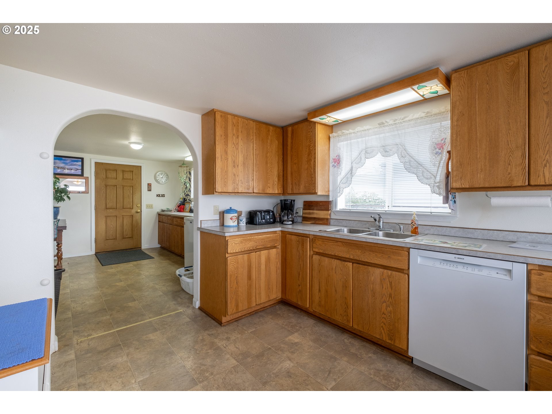 318 Highway 101 Depoe Bay, OR 97341 - Photo 12 of 47 a kitchen with granite countertop a stove a sink and a microwave