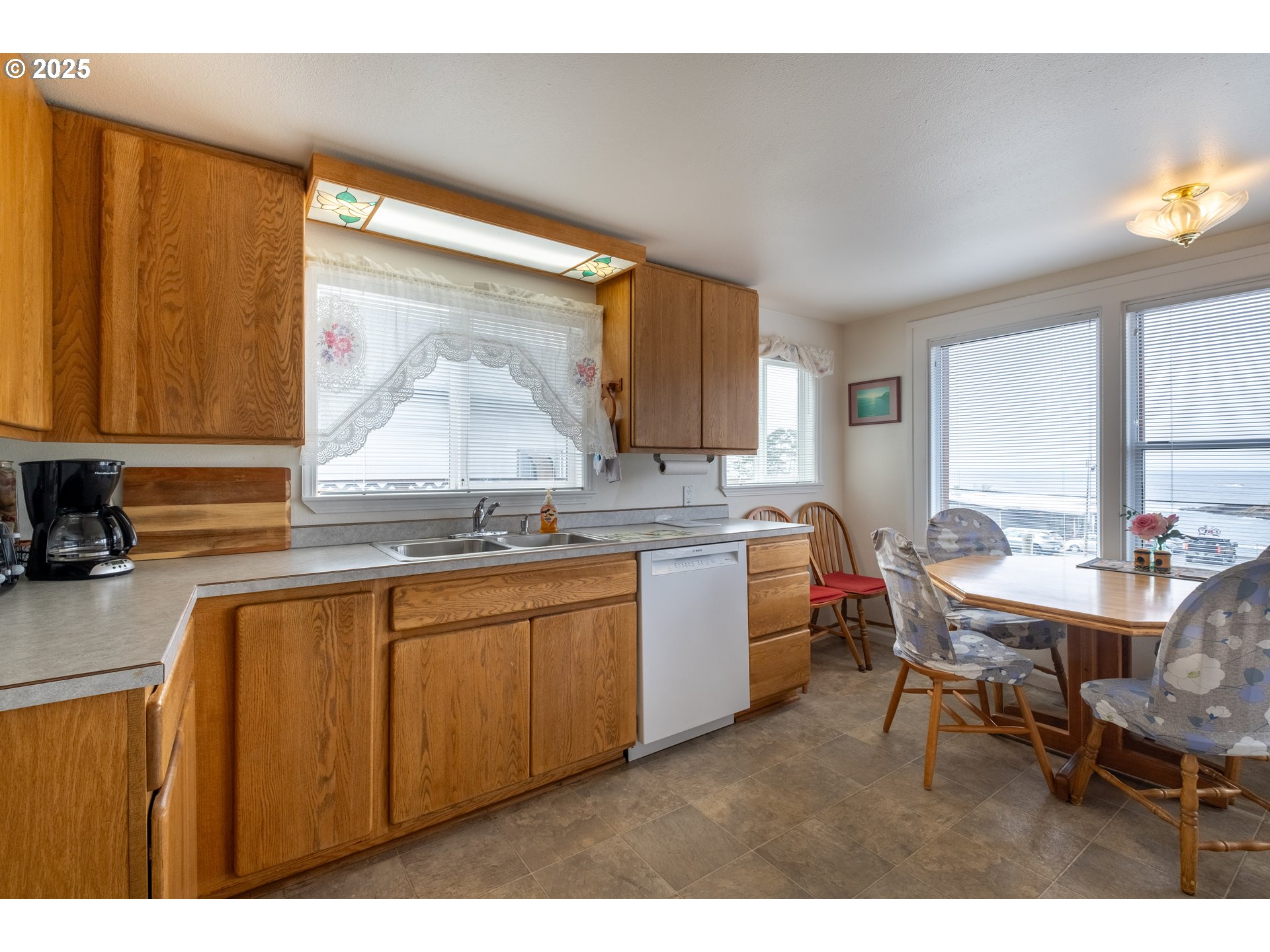 318 Highway 101 Depoe Bay, OR 97341 - Photo 13 of 47 a kitchen with kitchen island granite countertop a sink cabinets and wooden floor
